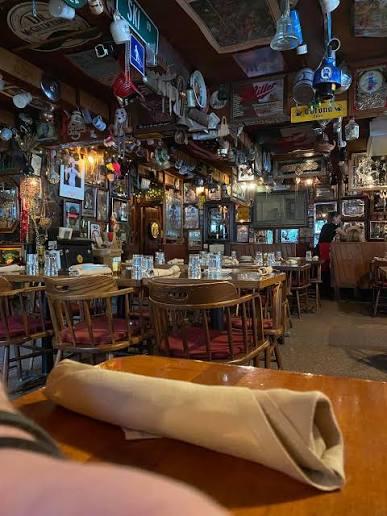 Cozy wood table setting looking out at the dining room booths and signs